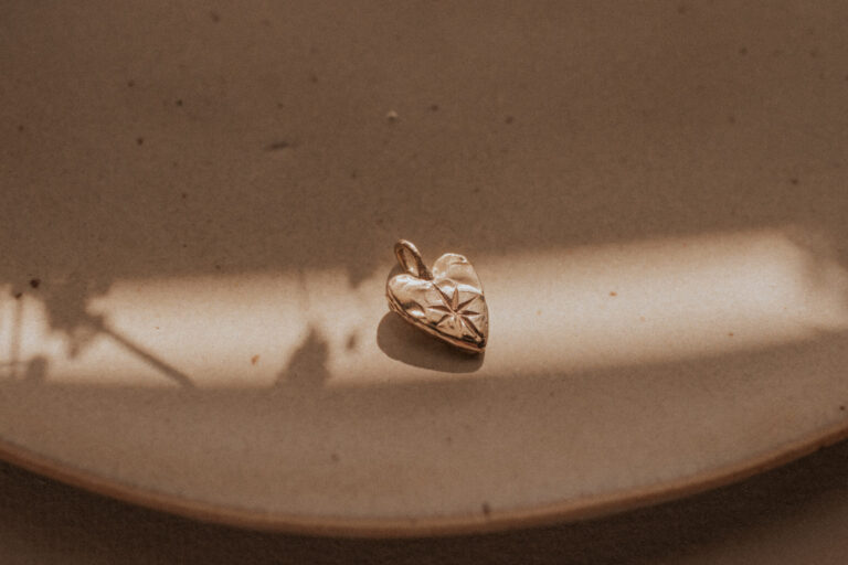 Gold heart charm with hand engraved star in the middle