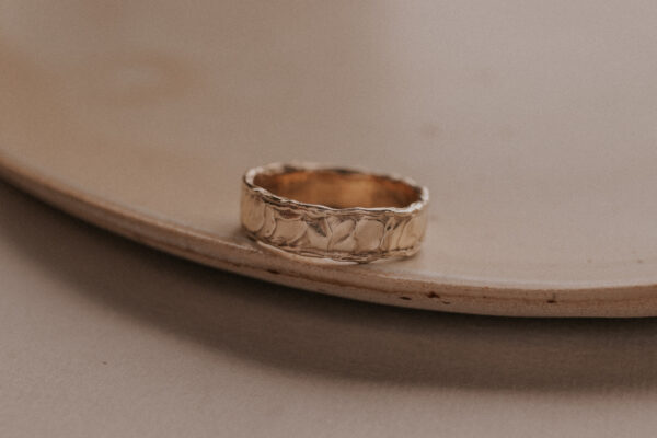 Gold ring with structure resembling the sand dunes