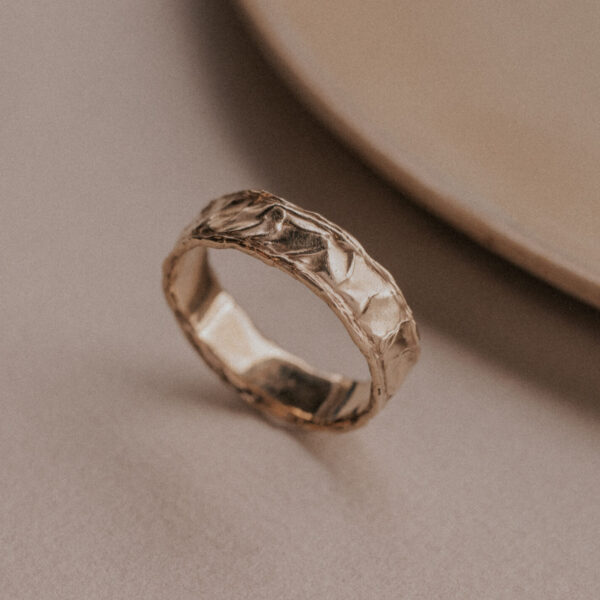 Gold ring with structure resembling the sand dunes
