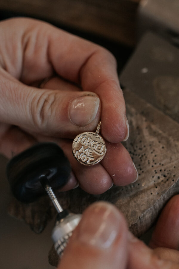Polishing Forget-Me-Not necklace charm
