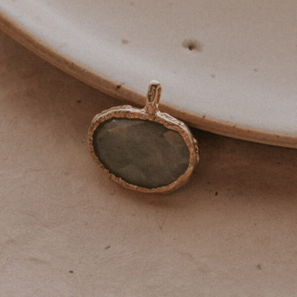 molten aquamarine gemstone charm on plate