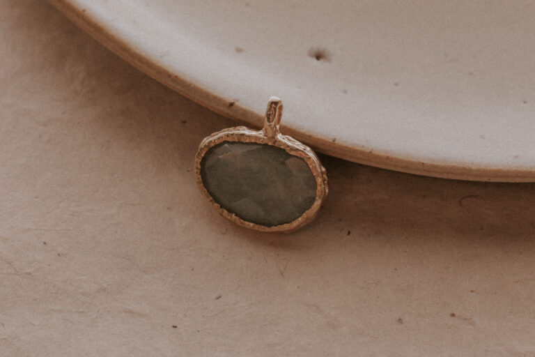 molten aquamarine gemstone charm on plate