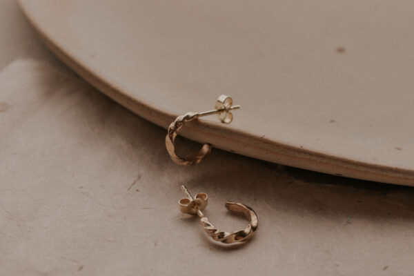 Tiny hoop earrings on plate