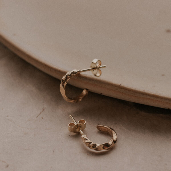 Tiny hoop earrings on plate